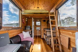 a tiny house with a bunk bed and a ladder at Deep Creek Sunset by Tiny Away in Romsey