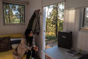 a little girl sitting on a table in a room at Raintree Farmstay by Tiny Away in Sarsfield