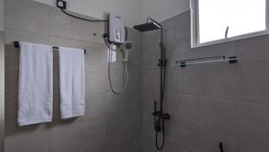 a shower in a bathroom with white towels at Breeze house in Tangalle +40 photos