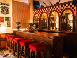 a bar with red stools around a wooden counter at The White Castle in Chartwell