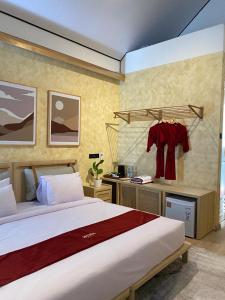 a bedroom with a large bed and a desk at HeHa Ocean Glamping dan Cabin in Ngundel
