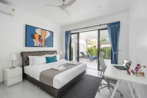 a bedroom with a bed and a desk and a computer at Buddha Bliss Luxury Villa in Ban Madua Wan +68 photos
