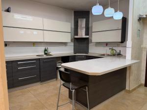 a kitchen with white cabinets and a white counter top at Har nof rooftop in Jerusalem +12 photos
