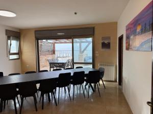 a conference room with a table and chairs in it at Har nof rooftop in Jerusalem