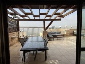 a patio with a table and chairs on a roof at Har nof rooftop in Jerusalem