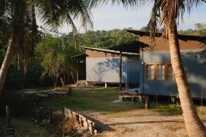 a house with a palm tree in front of it at Baan Rim Len Koh Kood in Ko Kood
