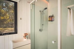 a bathroom with a sink and a shower at Mirror Reflections by Tiny Away in Tamborine