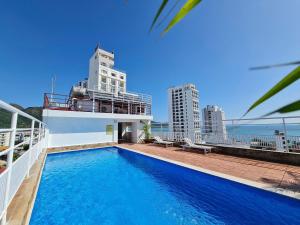 a swimming pool on top of a building with buildings at Media Nha Trang Hotel in Nha Trang
