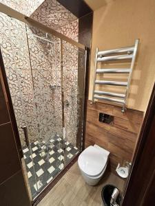 a bathroom with a toilet and a glass shower at Royal Historical Boutique Hotel in Baku +43 photos