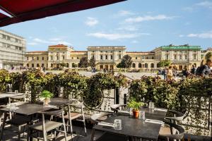 a patio with tables and chairs in front of a building at Vienna House by Wyndham Andel's Cracow in Krakow +72 photos
