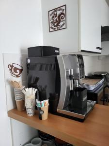 a coffee maker on a wooden shelf in a kitchen at Le Colibri in Fenouillet +18 photos