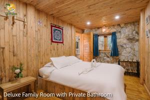 a bedroom with a bed in a wooden room at TV Palm Ecolodge Ha Giang in Ha Giang