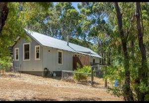 a small house in the woods with trees at Amara Creek Retreat in Margaret River Town