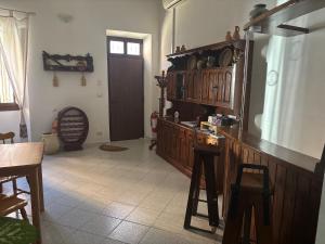 a kitchen with wooden cabinets and a table and chairs at Domo via Ozieri in Iglesias