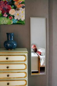 a bedroom with a dresser and a mirror at Sonho do Poeta in Sintra