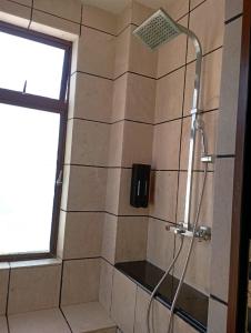 a shower in a bathroom with a window at GLX Private Pool Villa in Port Dickson +9 photos