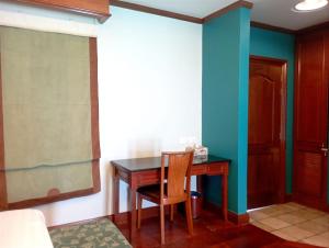 a room with a desk and a table and a chair at GLX Private Pool Villa in Port Dickson