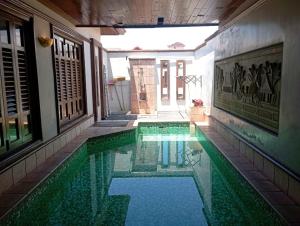 a swimming pool in the middle of a building at GLX Private Pool Villa in Port Dickson