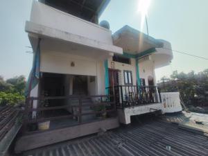 a church building with a balcony and a steeple at Abhishek Homestay in Dum Duma
