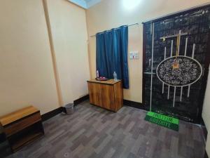 a room with a shower with a blue curtain at Abhishek Homestay in Dum Duma +3 photos