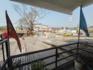a view of a street from a fence with flags at Abhishek Homestay in Dum Duma