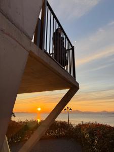 a man standing on a balcony watching the sunset at Gyeongnam goseong Hotel With7 in Goseong +19 photos