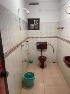 a bathroom with a toilet and a sink at Ridge Bae Homestay in Varkala +2 photos