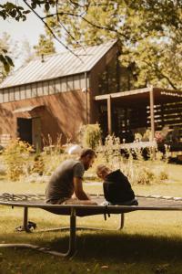 two people sitting on top of a trampoline at Cudomki nad jeziorem Krzywym in Piecki
