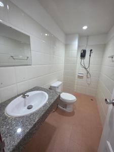 a bathroom with a sink and a toilet at Chokdee rooms kata in Kata Beach