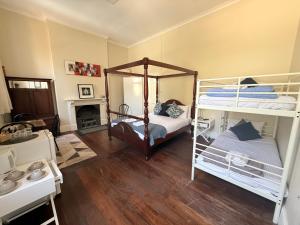 a bedroom with two bunk beds and a fireplace at Imperial Homestead in York +2 photos