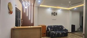 a waiting room with a chair and a desk at Royal Green Residency Chennai Airport in Chennai