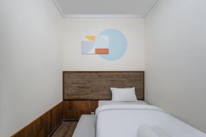 a small bedroom with two beds and a ceiling at Cove Casavanda in Serpong