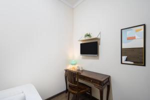 a desk in a room with a bed and a desk at Cove Casavanda in Serpong