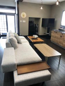 a living room with a couch and two tables at La Station in Bibai