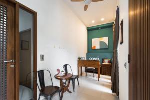 a room with a table and chairs and a desk at Cove Casavanda in Serpong