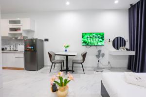a kitchen and living room with a table and chairs at Honey Vinhomes in Long Bình