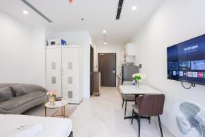 a living room with a couch and a table at Honey Vinhomes in Long Bình