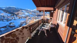 a balcony with a chair and a view of a mountain at Chalet Rezia in Savognin