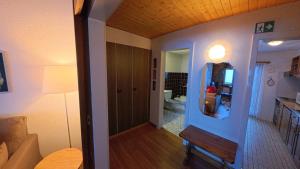 a hallway leading to a room with a kitchen at Chalet Rezia in Savognin