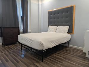 a bedroom with a large bed with a large headboard at Winsor Hotel in San Francisco +9 photos