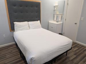a large white bed with a large headboard in a room at Winsor Hotel in San Francisco