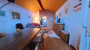 a living room with a large wooden table and a couch at Chalet Rezia in Savognin