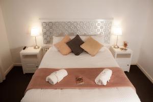 a bedroom with a bed with two pillows and two tables at Imperial Homestead in York