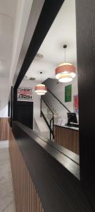 a lobby of a fast food restaurant with lights at New Samay Hostel in Seville