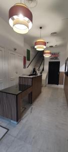 an empty lobby with a desk and a staircase at New Samay Hostel in Seville