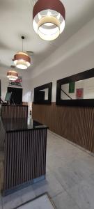 a lobby with a reception desk and lights at New Samay Hostel in Seville +55 photos