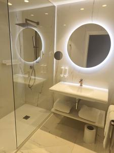 a bathroom with a sink and a mirror at Senator Port Mahon in Mahón