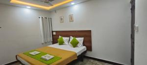 a bedroom with a bed with two towels on it at Hotel Royal Green Inn in Chennai