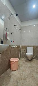 a bathroom with a shower and a toilet and a sink at Hotel Royal Green Inn in Chennai