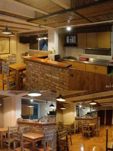 a room with tables and chairs and a kitchen at Hotel Confortel in Armenia